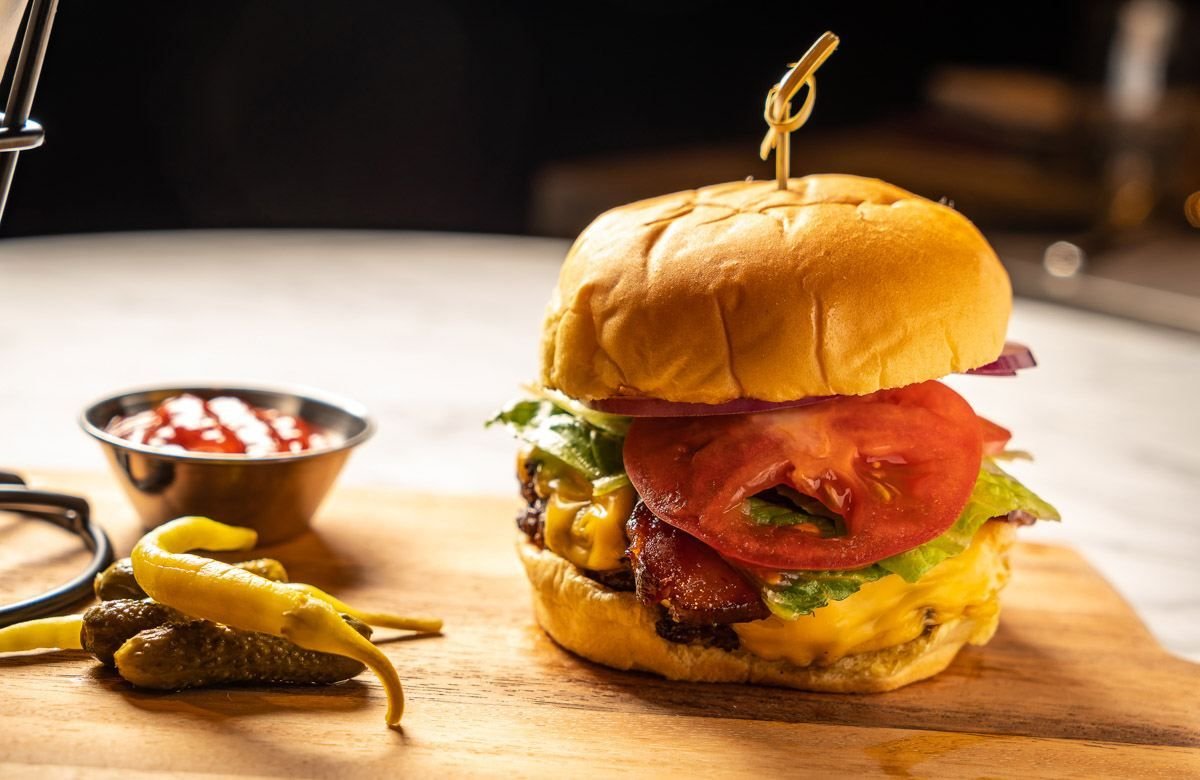 Burger on a wooden board with peppers